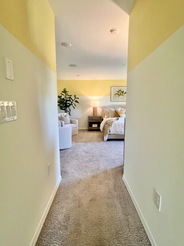 Richmond Cove Palm Bay Holiday Builders Model Home primary bedroom hallway