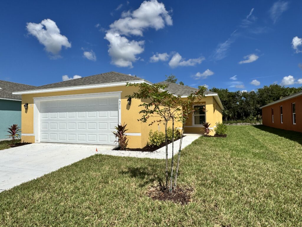 Richmond Cove Palm Bay Holiday Builders yellow house for sale
