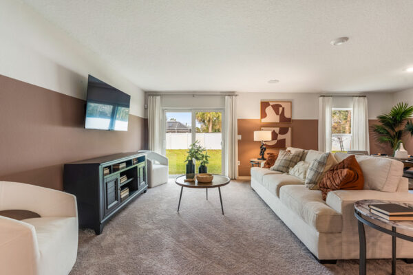 View of living room and patio doors in a Holiday Builders model home
