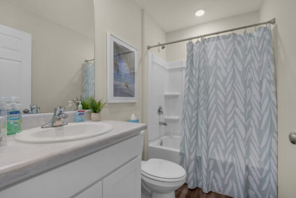 The guest bathroom of the Addison floorplan by Holiday Builders is from our Value collection in the Gulf region.