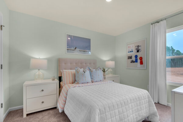 The guest bedroom of the Addison floorplan by Holiday Builders is from our Value collection in the Gulf region.