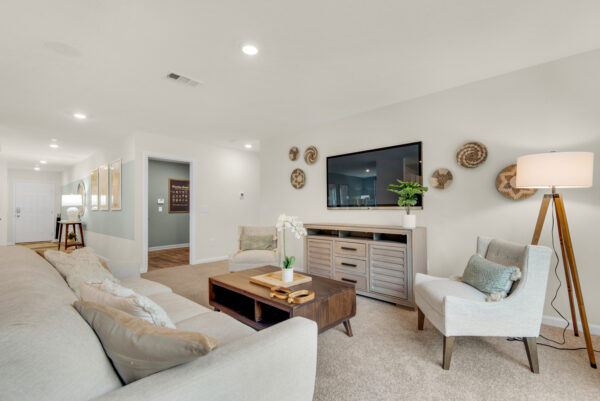 The living room of the Addison floorplan by Holiday Builders is from our Value collection in the Gulf region.