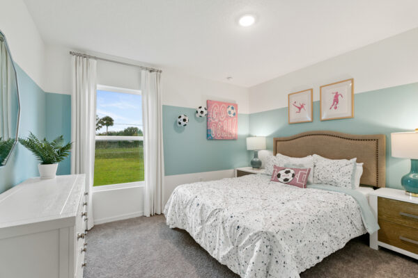 A soccer themed girl's bedroom in the Sylvester floorplan from the Value collection by Holiday Builders.