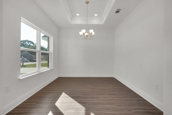 The formal dining area with coffer ceilings in the Ariana floorplan from the Cornerstone collection by Holiday Builders.
