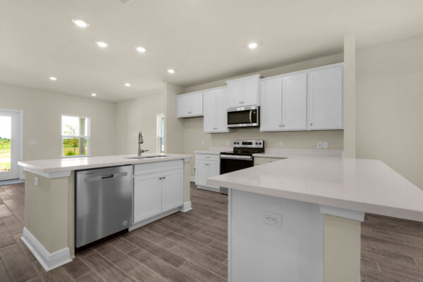 The kitchen of the Bay floorplan from the Cornerstone Collection by Holiday Builders.