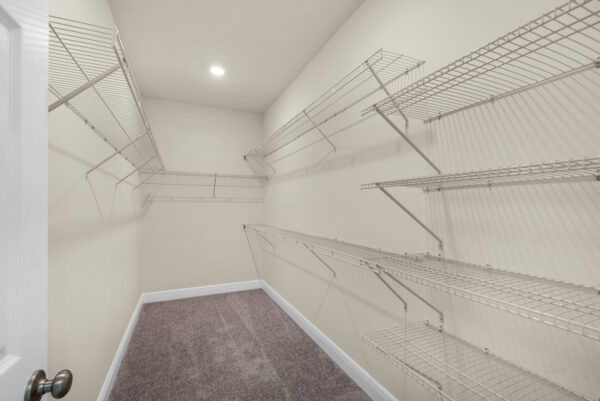 The owners walk-in closet of the Bay floorplan from the Cornerstone Collection by Holiday Builders.