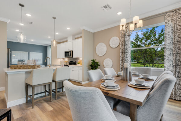 The kitchen and dining area of the Biscayne floorplan from the Cornerstone collection by Holiday Builders.