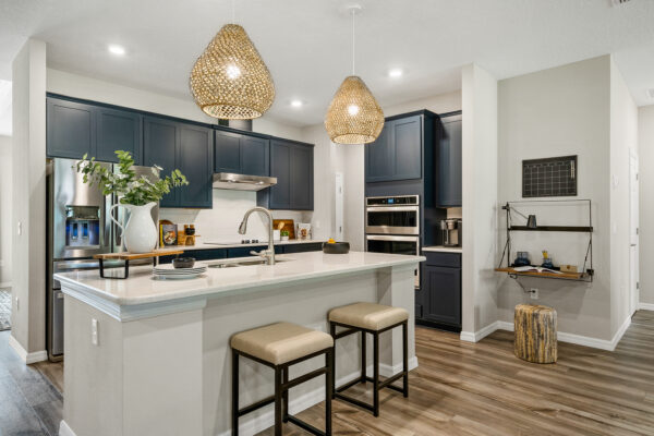 Beautiful blue cabinet kitchen in the Captiva floorplan from the Cornerstone collection by Holiday Builders.