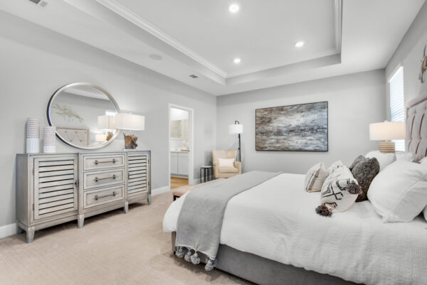 The master bedroom with coffer ceiling in the Carlton floorplan from the Cornerstone collection by Holiday Builders.