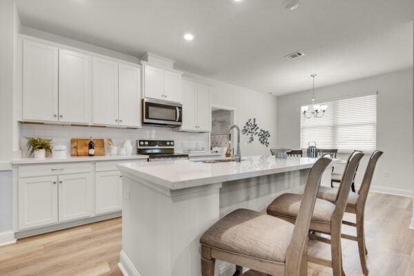 The kitchen in the Carlton floorplan from the Cornerstone collection by Holiday Builders.