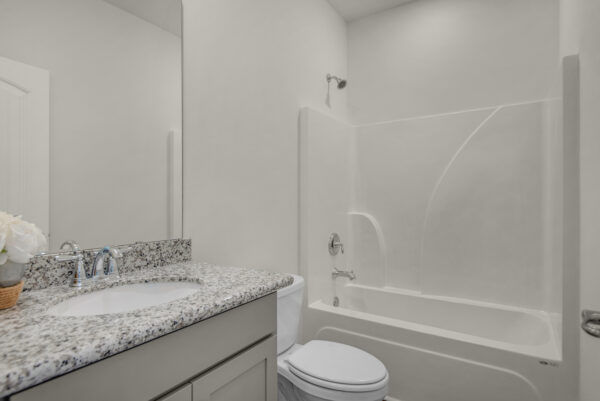 The guest bath in the Cypress floorplan from the Cornerstone collection by Holiday Builders.