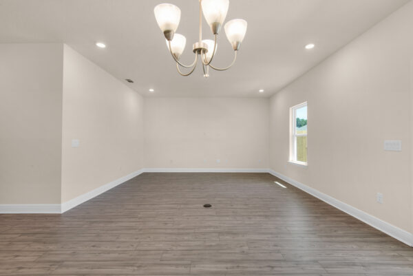 The living and dining areas of the Denham floorplan of the Cornerstone collection by Holiday Builders.