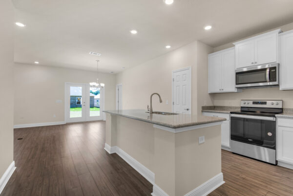 The kitchen inf the Denham floorplan of the Cornerstone collection by Holiday Builders.