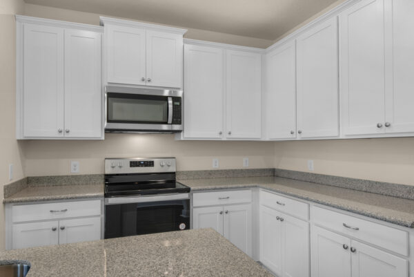 The kitchen in the Denham floorplan of the Cornerstone collection by Holiday Builders.