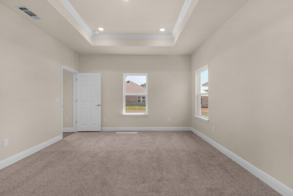 The master bedroom in the Denham floorplan of the Cornerstone collection by Holiday Builders.