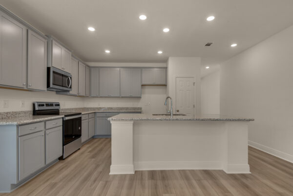 The kitchen in the Destin floorplan from the Cornerstone collection by Holiday Builders.