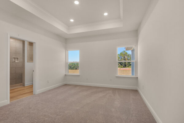 The master bedroom in the Destin floorplan from the Cornerstone collection by Holiday Builders.