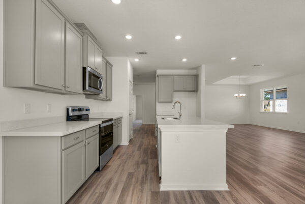 The kitchen in the Dora floorplan from the Cornerstone collection by Holiday Builders.