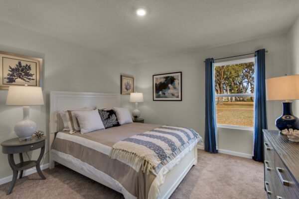A gray striped guest bedroom in the Grayton floorplan from the Value collection by Holiday Builders.