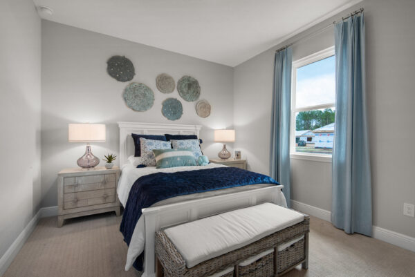 A guest bedroom in the Hamilton floorplan from the Cornerstone collection by Holiday Builders.