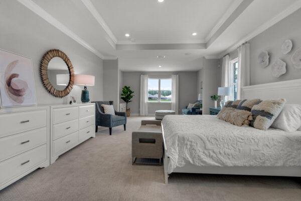 The master bedroom and sitting area in the Hamilton floorplan from the Cornerstone collection by Holiday Builders.