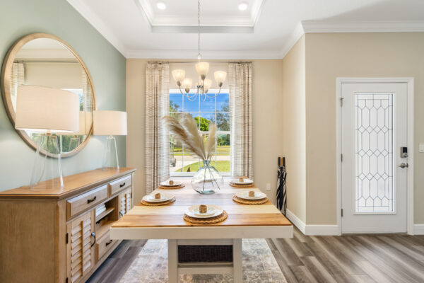 The dining room in the Highland floorplan from the Cornerstone collection by Holiday Builders.
