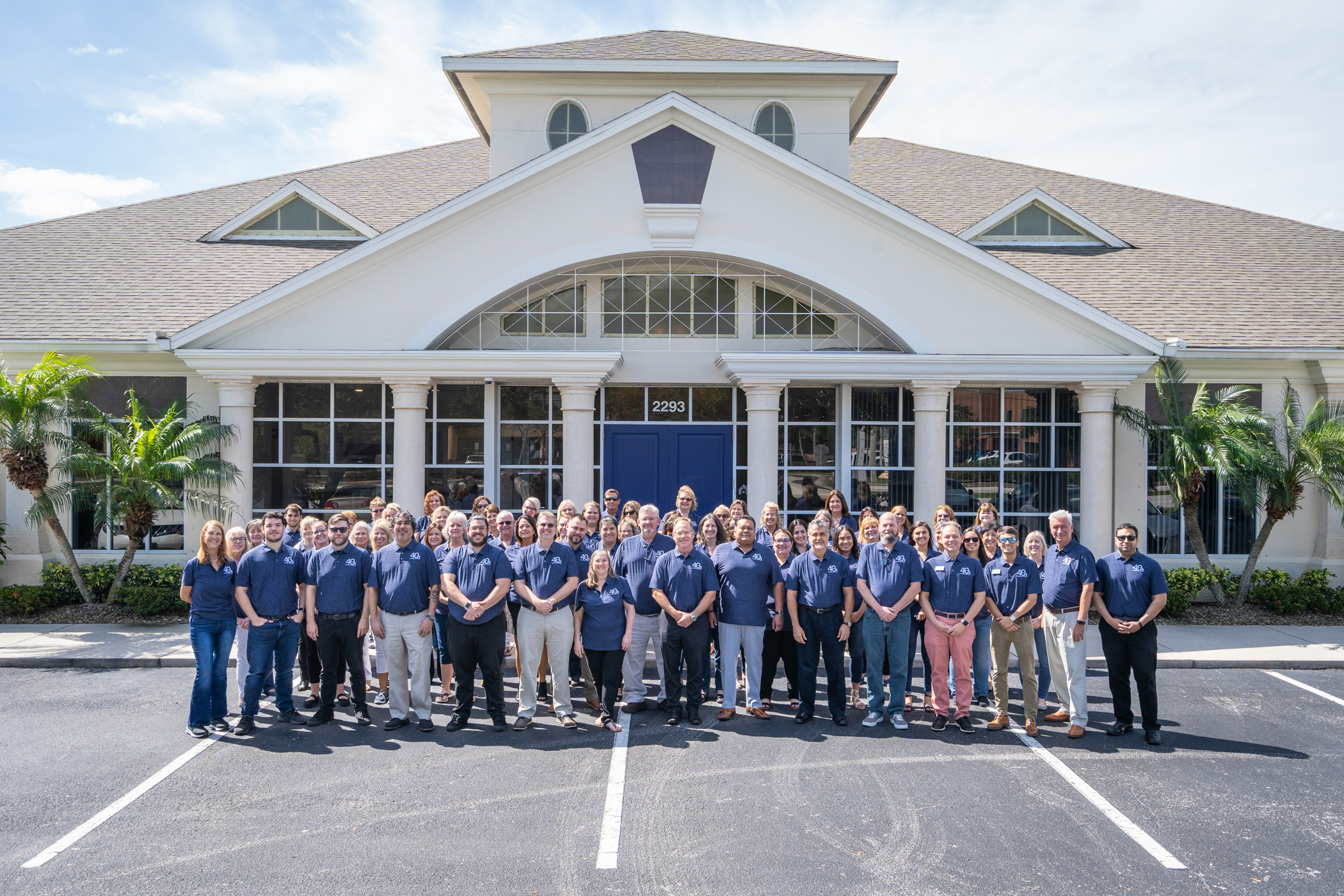 Holiday Builders employees gather for a photo in April 2023 in celebration of the company's 40th anniversary.