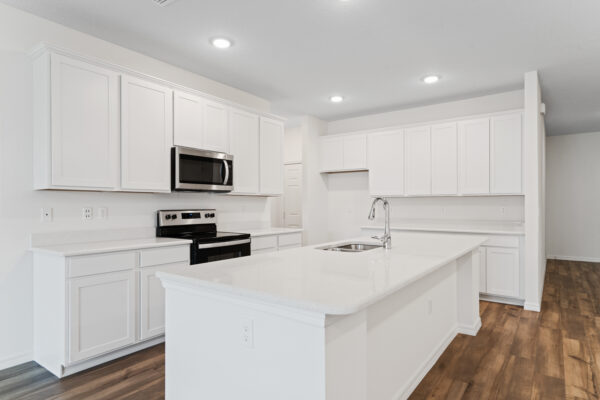 An all white kitchen in the Naples floorplan from the Cornerstone collection by Holiday Builders.