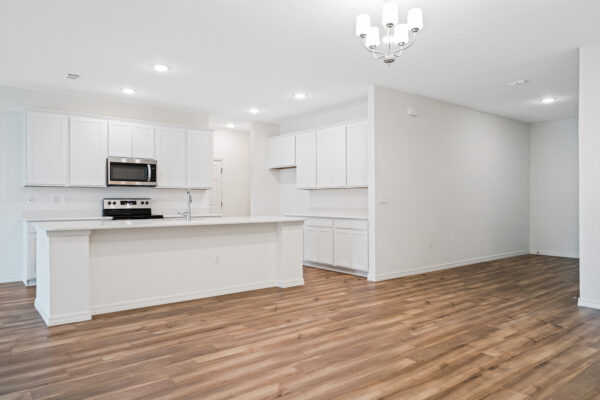The dining area and kitchen in the Naples floorplan from the Cornerstone collection by Holiday Builders.