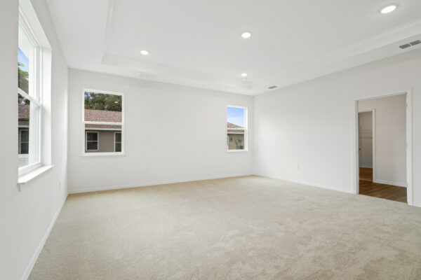 The master bedroom in the Naples floorplan from the Cornerstone collection by Holiday Builders.