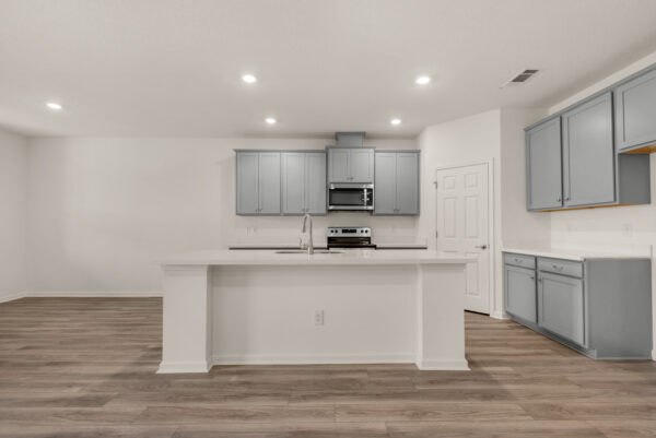 The kitchen in the Osprey floorplan from the Cornerstone collection by Holiday Builders.