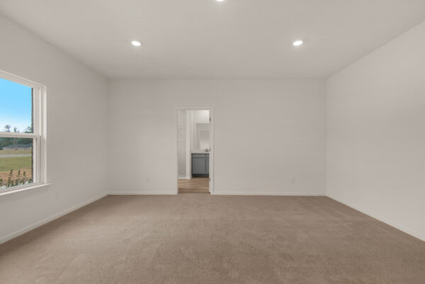 The master bedroom in the Osprey floorplan from the Cornerstone collection by Holiday Builders.