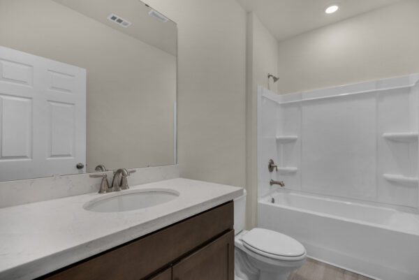 The guest bath in the Osprey Floorplan from the Cornerstone Collection by Holiday Builders.