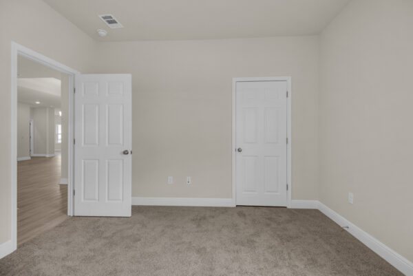 The guest bedroom in the Osprey Floorplan from the Cornerstone Collection by Holiday Builders.
