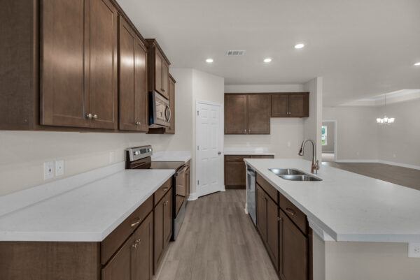 The kitchen in the Osprey Floorplan from the Cornerstone Collection by Holiday Builders.