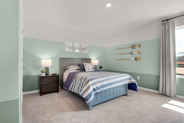 A rowing themed bedroom in the Palmer floorplan from the Value collection by Holiday Builders.