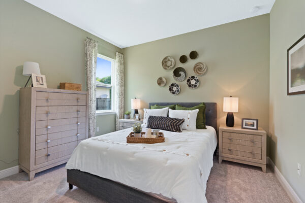 The guest bedroom in the Sanibel floorplan from the Cornerstone collection by Holiday Builders.