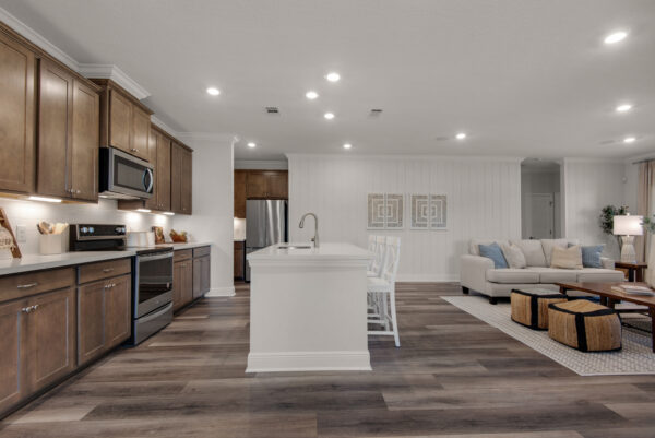 The kitchen and living areas in the Santa Rosa floorplan from the Cornerstone collection by Holiday Builders.