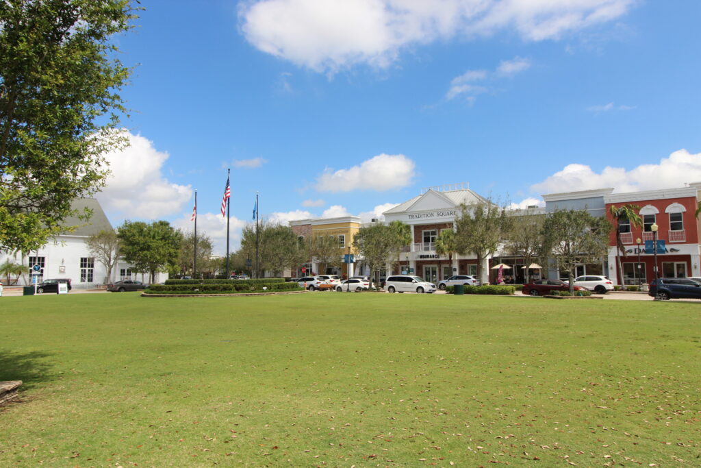 View of the shopping street of Tradition in Port St Lucie from the grassy park.