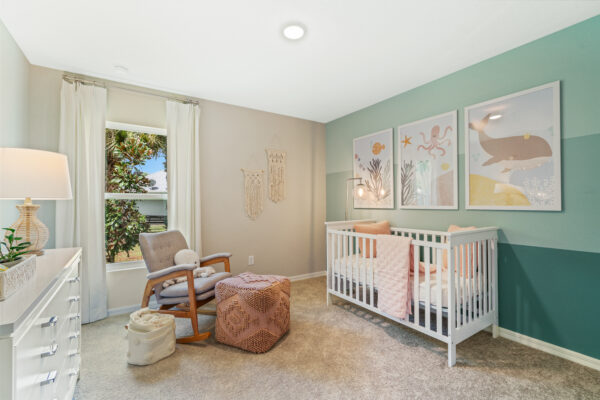 A baby's room in the Sylvester floorplan from the Value collection by Holiday Builders.