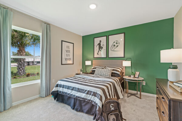 A soccer themed bedroom in the Sylvester floorplan from the Value collection by Holiday Builders.